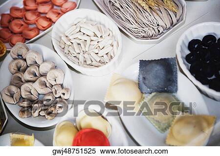 Close-up of uncooked assorted pastas and dumplings in trays View Large Photo Image Stock Photography - Close-up of uncooked assorted pastas and dumplings in trays. Fotosearch