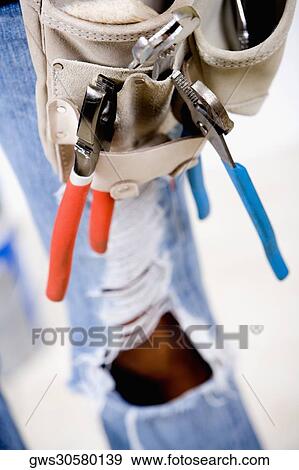 Close-up of work tools in a tool belt View Large Photo Image Stock Photo - Close-up of work tools in a tool belt. Fotosearch