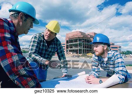 Stock Photography - Construction crew looking at blueprints . Fotosearch