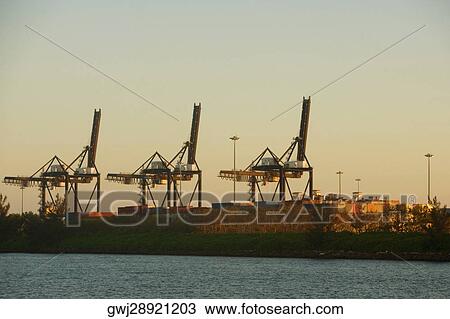 Crane and cargo containers at a commercial dock, Miami, Florida, USA View Large Photo Image Stock Image - Crane and cargo containers at a commercial dock, Miami, Florida, USA. Fotosearch