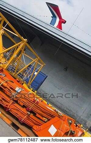 Crane near a container ship at the port View Large Photo Image Stock Photo - Crane near a container ship at the port. Fotosearch