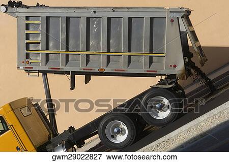 Stock Photo - Dump truck dumping concrete. Fotosearch