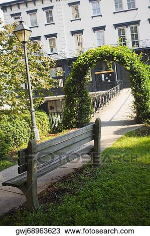 Stock Image - Entrance of a footbridge covered with ivy, Savannah, Georgia, USA. Fotosearch