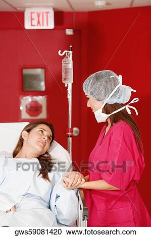 Female doctor consoling a female patient View Large Photo Image Stock Image - Female doctor consoling a female patient. Fotosearch