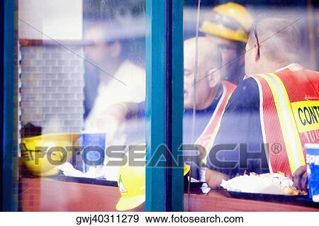 Four men with their food behind a window View Large Photo Image Stock Photo - Four men with their food behind a window. Fotosearch