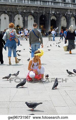 Girl crouching near pigeons, Venice, Veneto, Italy View Large Photo Image Stock Photo - Girl crouching near pigeons, Venice, Veneto, Italy. Fotosearch