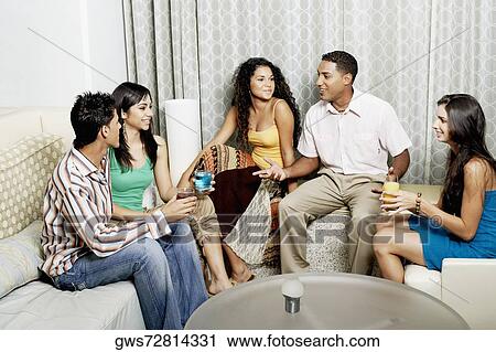 Group of friends talking to each other and smiling View Large Photo Image Stock Image - Group of friends talking to each other and smiling. Fotosearch