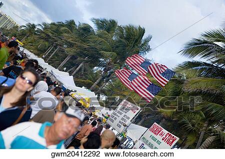 Stock Image - Group of people in a street market. Fotosearch
