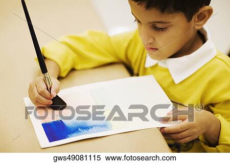 High angle view of a boy painting View Large Photo Image Stock Photography - High angle view of a boy painting. Fotosearch
