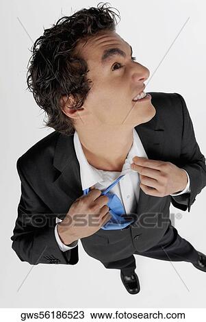 High angle view of a businessman pulling his tie View Large Photo Image Stock Image - High angle view of a businessman pulling his tie. Fotosearch