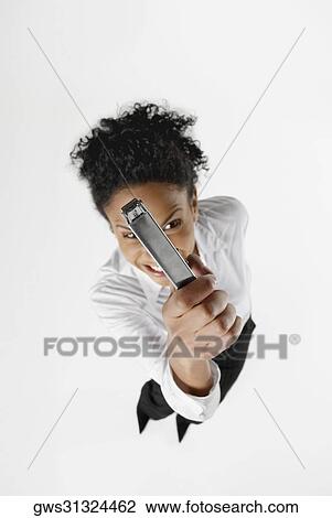 High angle view of a businesswoman showing a stapler and clenching her teeth View Large Photo Image Stock Image - High angle view of a businesswoman showing a stapler and clenching her teeth. Fotosearch