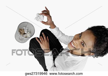 High angle view of a businesswoman throwing a crumpled sheet of paper into a wastepaper basket View Large Photo Image Stock Photograph - High angle view of a businesswoman throwing a crumpled sheet of paper into a wastepaper basket. Fotosearch