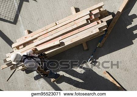 High angle view of a carpenter at a construction site View Large Photo Image Stock Image - High angle view of a carpenter at a construction site. Fotosearch