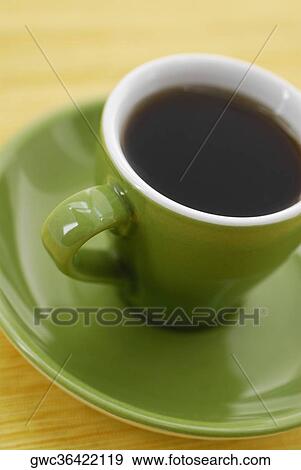 High angle view of a cup of black tea on a saucer View Large Photo Image Stock Photo - High angle view of a cup of black tea on a saucer. Fotosearch