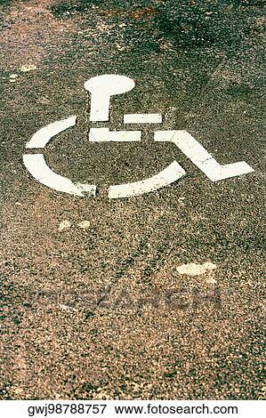 Stock Photo - High angle view of a disabled sign on the road. Fotosearch