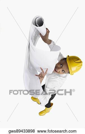 High angle view of a female architect opening blueprints View Large Photo Image Stock Photo - High angle view of a female architect opening blueprints. Fotosearch