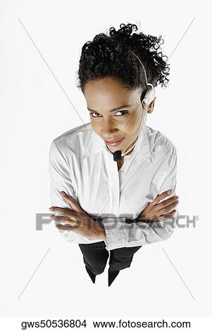 High angle view of a female customer service representative standing with her arms folded View Large Photo Image Picture - High angle view of a female customer service representative standing with her arms folded. Fotosearch