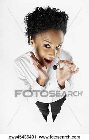 Stock Image - High angle view of a female customer service representative talking on a headset. Fotosearch