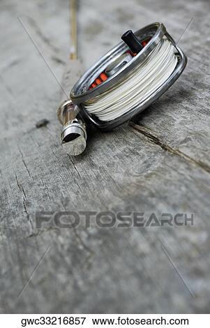 High angle view of a fishing reel and a fishing rod View Large Photo Image Stock Photo - High angle view of a fishing reel and a fishing rod. Fotosearch