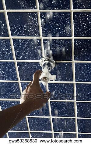 High angle view of a human hand turning a shower knob View Large Photo Image Stock Image - High angle view of a human hand turning a shower knob. Fotosearch