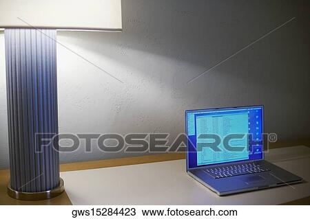 High angle view of a laptop beside a lampshade View Large Photo Image Stock Image - High angle view of a laptop beside a lampshade. Fotosearch