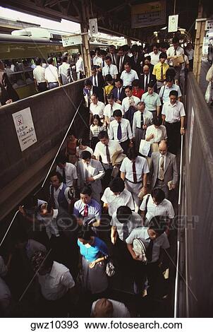 High angle view of a large group of people walking at a railroad station, Tokyo Prefecture, Japan View Large Photo Image Stock Image - High angle view of a large group of people walking at a railroad station, Tokyo Prefecture, Japan. Fotosearch