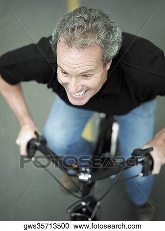 High angle view of a mature man cycling View Large Photo Image Stock Image - High angle view of a mature man cycling. Fotosearch