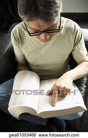 High angle view of a mature man reading a book View Large Photo Image Stock Photograph - High angle view of a mature man reading a book. Fotosearch