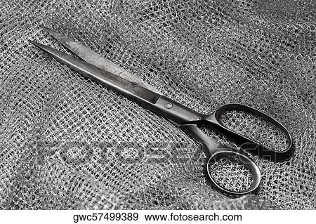 Stock Photo - High angle view of a pair of scissors on fabric. Fotosearch