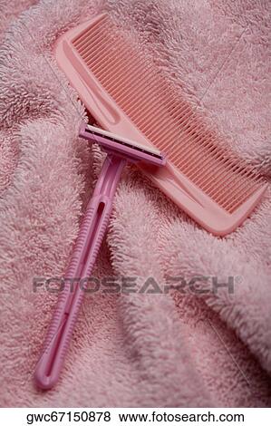 High angle view of a razor and a comb on a towel View Large Photo Image Stock Photo - High angle view of a razor and a comb on a towel. Fotosearch