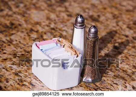 High angle view of a salt and pepper shaker on the table with a napkin holder View Large Photo Image Stock Photography - High angle view of a salt and pepper shaker on the table with a napkin holder. Fotosearch