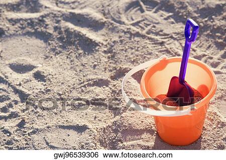 High angle view of a sand pail and shovel on the beach View Large Photo Image Stock Photograph - High angle view of a sand pail and shovel on the beach. Fotosearch