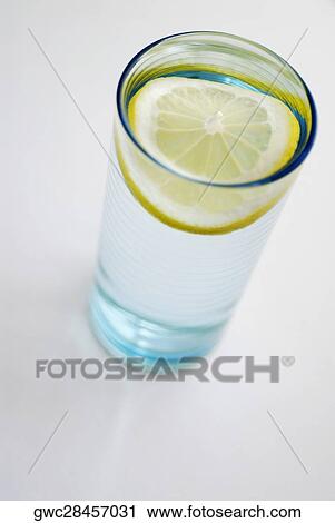 High angle view of a slice of lemon in a glass View Large Photo Image Stock Image - High angle view of a slice of lemon in a glass. Fotosearch