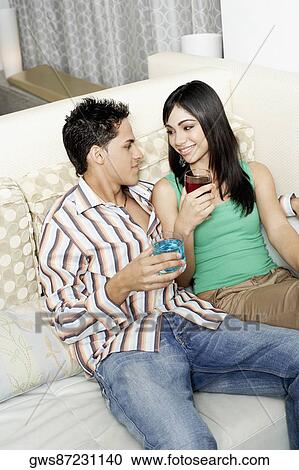 High angle view of a teenage girl and a young man sitting on a couch View Large Photo Image Stock Image - High angle view of a teenage girl and a young man sitting on a couch. Fotosearch