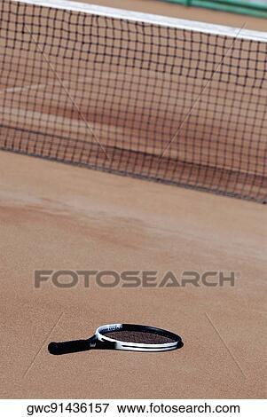 Stock Photo - High angle view of a tennis racket on a tennis court. Fotosearch