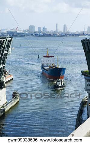 High angle view of a tugboat pulling a cargo container View Large Photo Image Stock Photograph - High angle view of a tugboat pulling a cargo container. Fotosearch