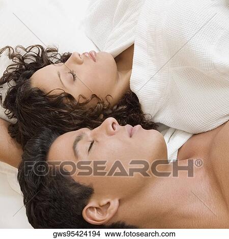 High angle view of a young man and a teenage girl sleeping View Large Photo Image Picture - High angle view of a young man and a teenage girl sleeping. Fotosearch