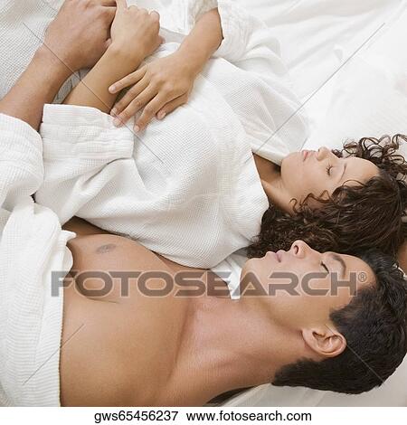 High angle view of a young man and a teenage girl sleeping View Large Photo Image Stock Photo - High angle view of a young man and a teenage girl sleeping. Fotosearch