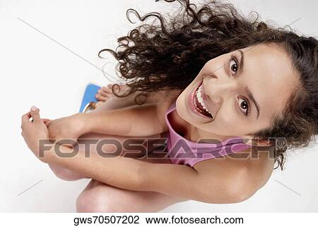 High angle view of a young woman crouching on a weight scale View Large Photo Image Stock Image - High angle view of a young woman crouching on a weight scale. Fotosearch