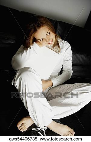 High angle view of a young woman hugging her laptop View Large Photo Image Stock Photo - High angle view of a young woman hugging her laptop. Fotosearch