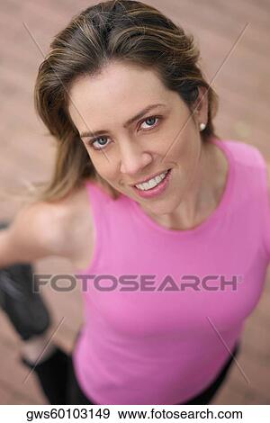 High angle view of a young woman stretching her leg View Large Photo Image Stock Photo - High angle view of a young woman stretching her leg. Fotosearch