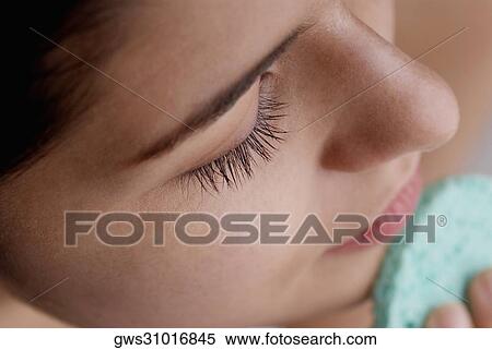 High angle view of a young woman scrubbing her face with a sponge View Large Photo Image Stock Photography - High angle view of a young woman scrubbing her face with a sponge. Fotosearch