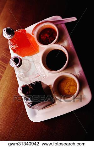 High angle view of bowls of soups with sauce bottles on a tray View Large Photo Image Stock Image - High angle view of bowls of soups with sauce bottles on a tray. Fotosearch