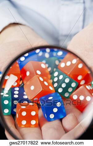 High angle view of dice in a man's hands viewed through a magnifying glass View Large Photo Image Stock Image - High angle view of dice in a man's hands viewed through a magnifying glass. Fotosearch