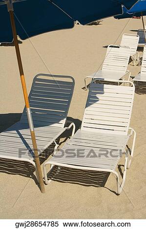 High angle view of empty chairs on the beach View Large Photo Image Stock Photography - High angle view of empty chairs on the beach. Fotosearch