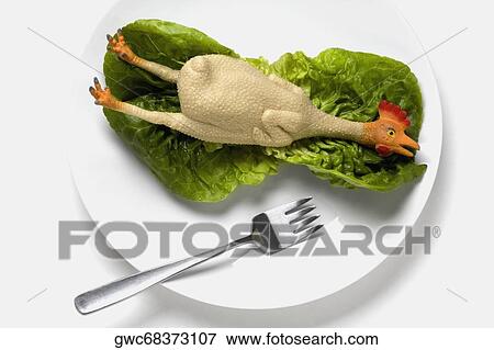 High angle view of figurine of a chicken on a lettuce leaf View Large Photo Image Stock Photo - High angle view of figurine of a chicken on a lettuce leaf. Fotosearch