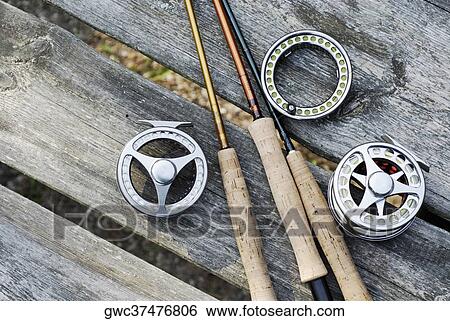 Stock Photograph - High angle view of fishing rods with fishing reels. Fotosearch