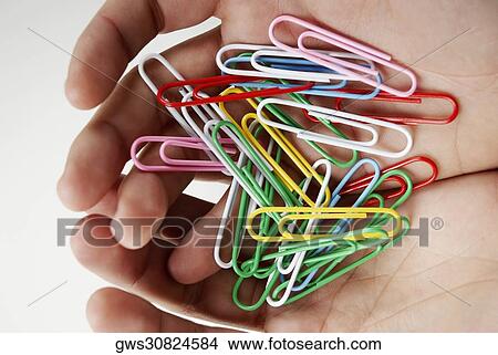 High angle view of paper clips in person's hands View Large Photo Image Picture - High angle view of paper clips in person's hands. Fotosearch