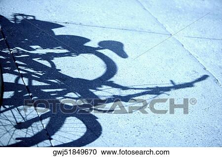 High angle view of the shadow of a bicycle View Large Photo Image Stock Image - High angle view of the shadow of a bicycle. Fotosearch