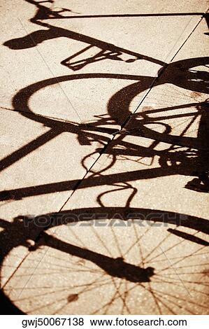 High angle view of the shadow of a bicycle View Large Photo Image Stock Photo - High angle view of the shadow of a bicycle. Fotosearch